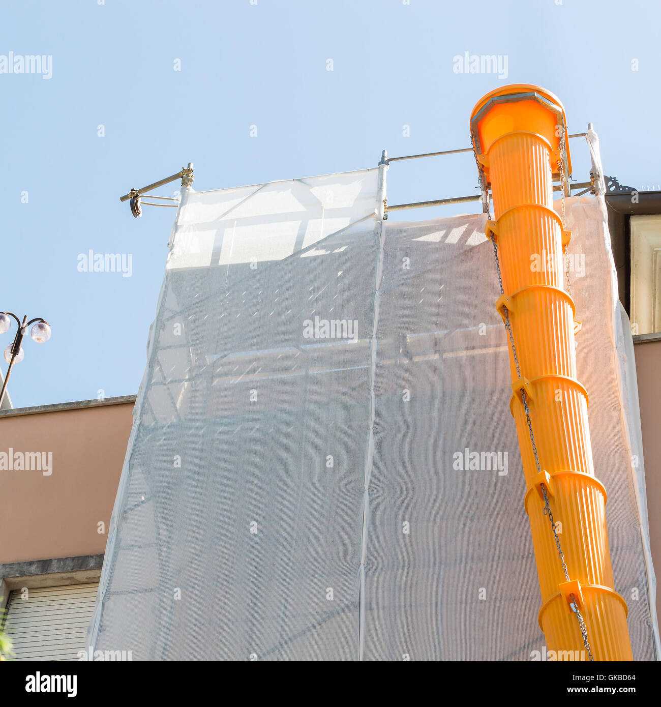 Scaffolding covered with modular slide for debris and rubble Stock Photo