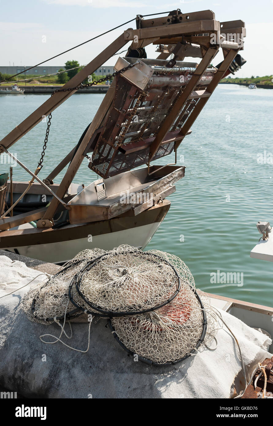 Pot made of nylon net with more rooms suitable for fishing in the lagoon to dry on the pier. Stock Photo