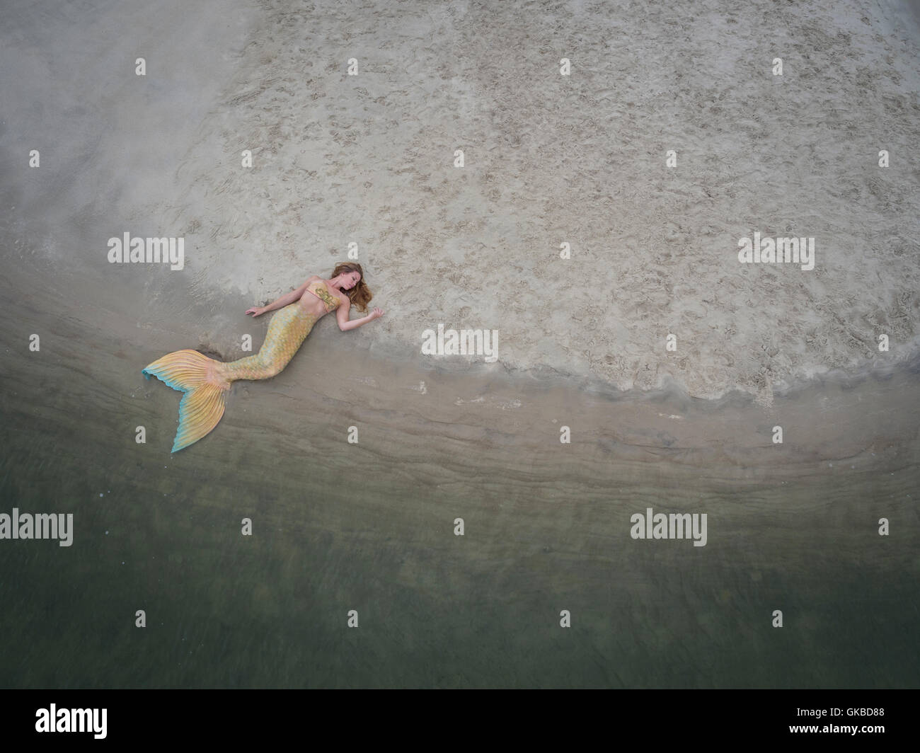 Mermaid laying on a sandbar in Virginia Beach, VA Stock Photo