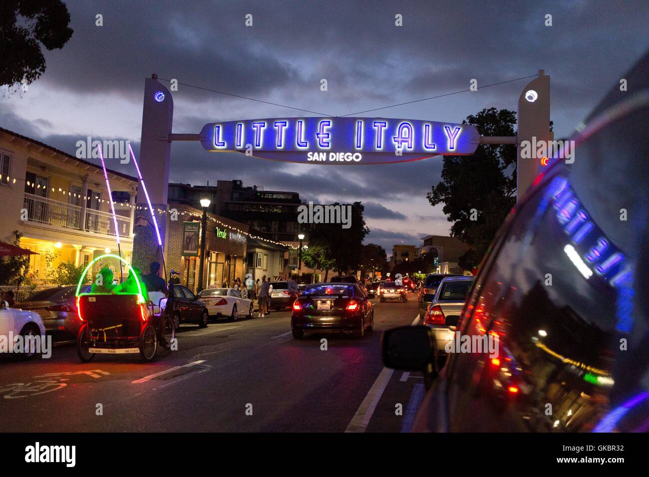 Traffic in the evening on India Street in Little Italy and illuminated street sign standing out against the dramatic sky, in August 2016. | usage worldwide Stock Photo