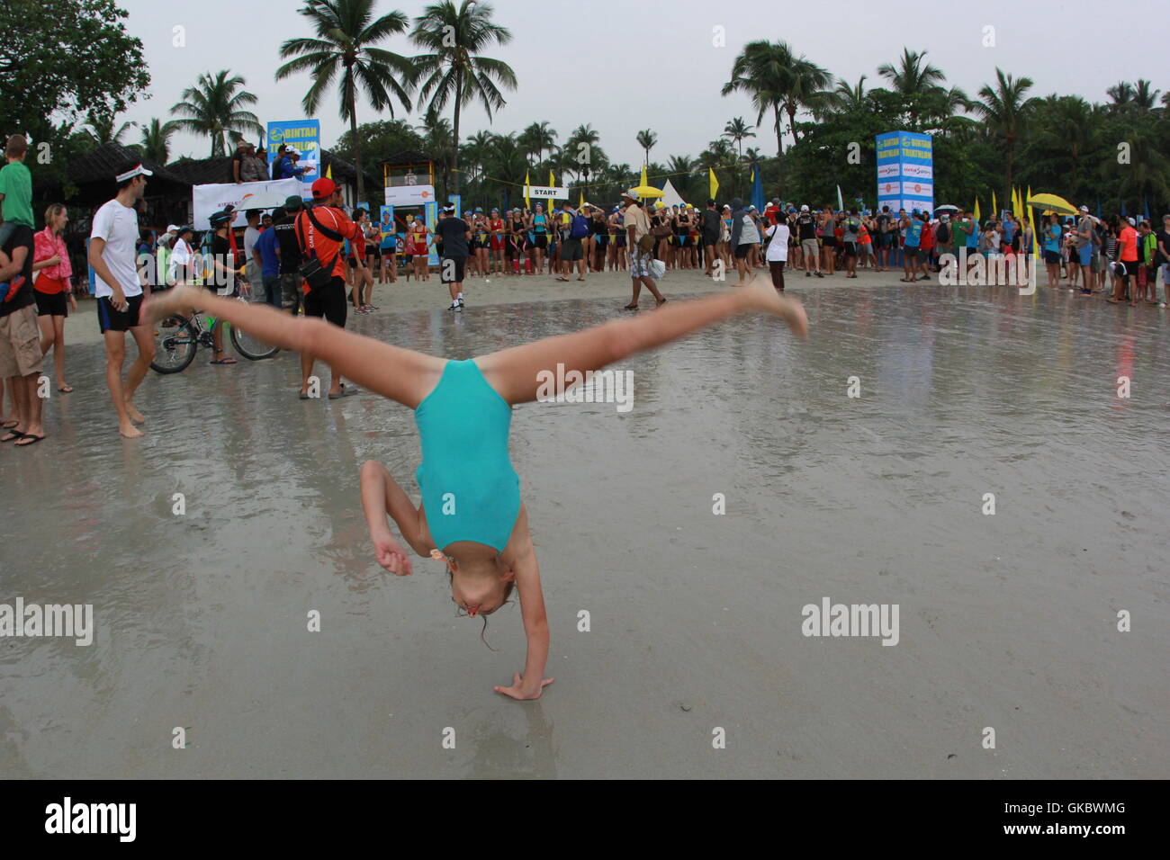 A girl gymnastics at beach in Bintan, Indonesia. Photo by Yuli Seperi