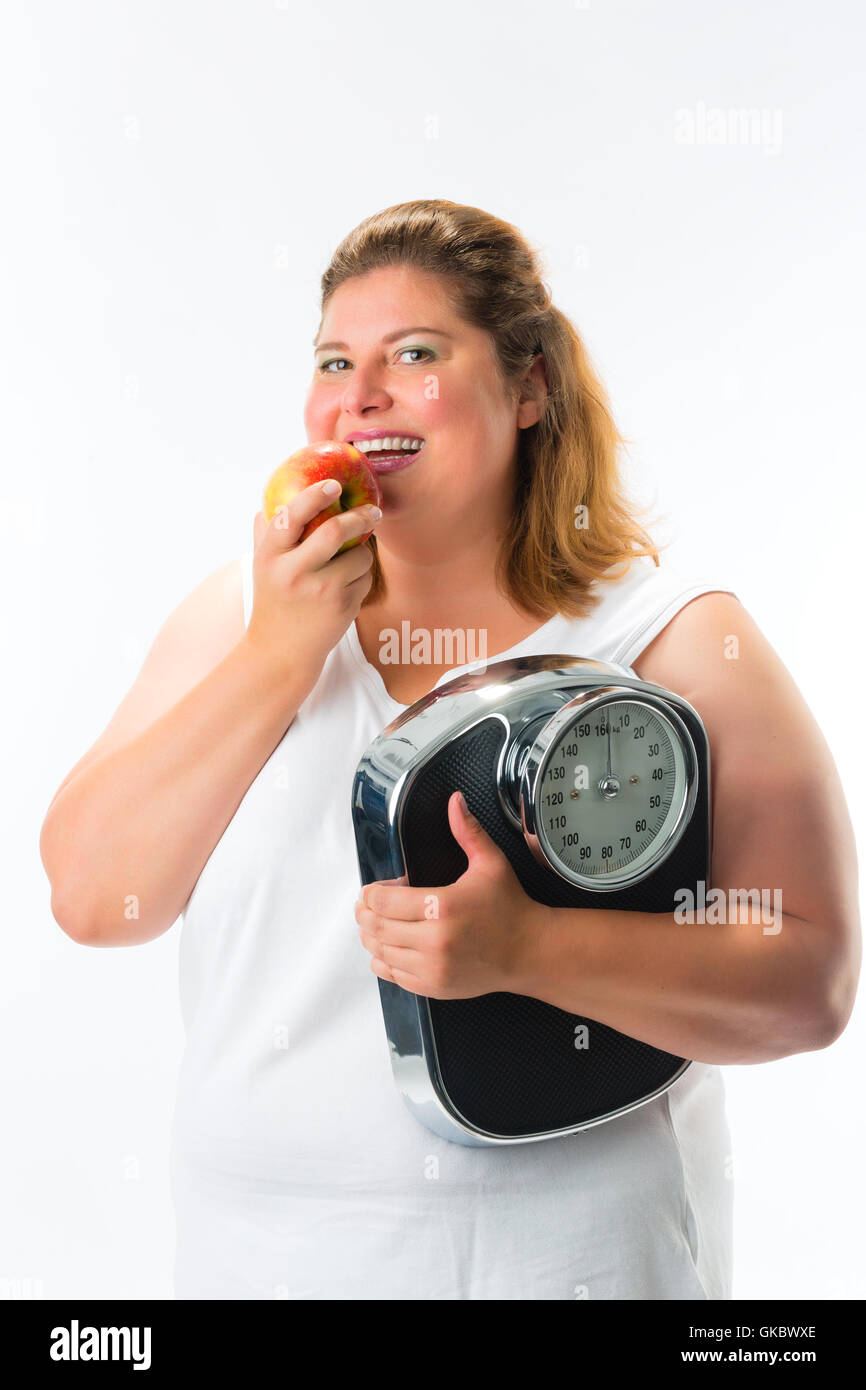 young woman with scales under his arm and apple Stock Photo