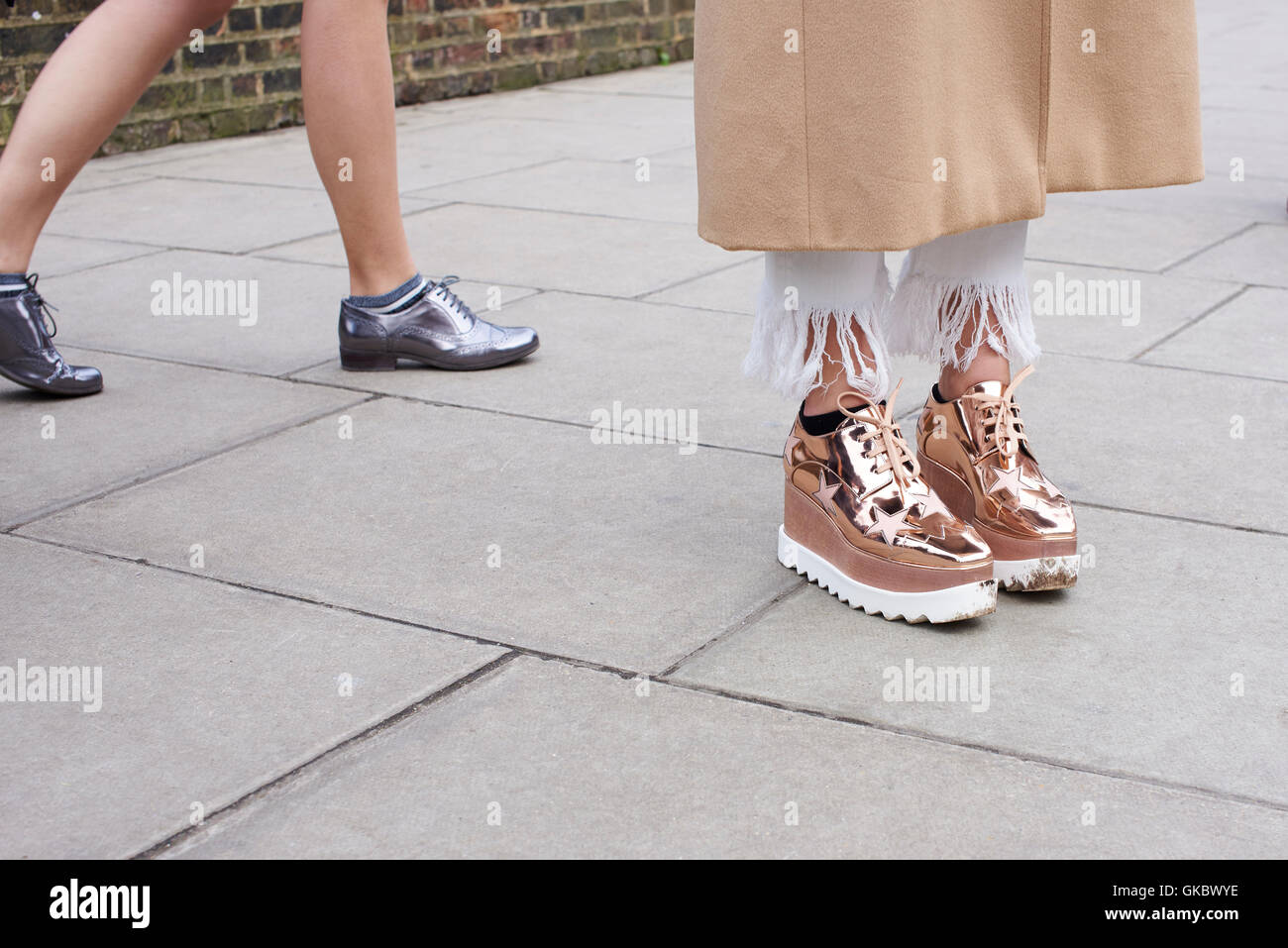 Low section of two trendy women’s feet in the street Stock Photo