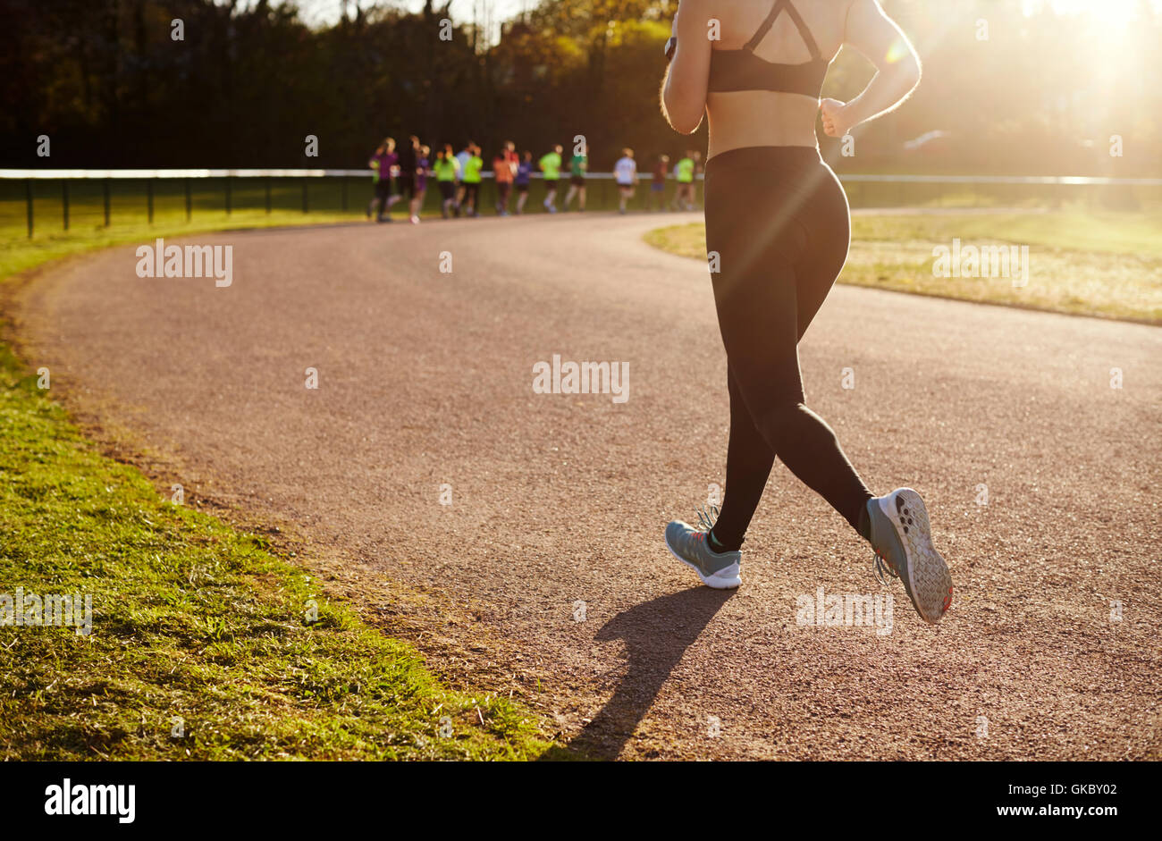 Close Up Of Woman Exercising On Outdoor Running Track Stock Photo