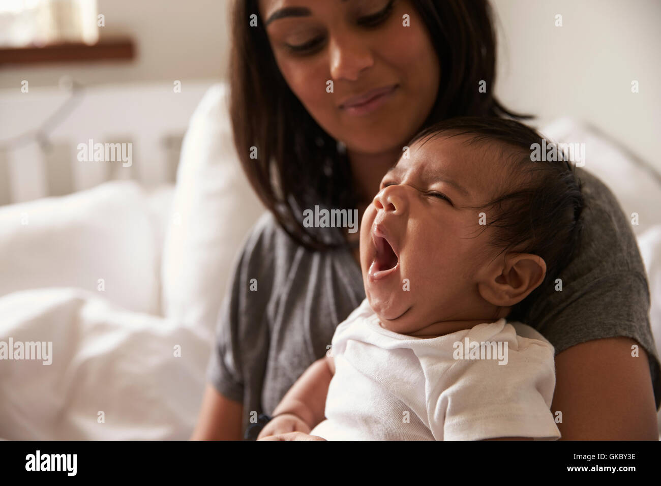 Baby sitting on bed hi-res stock photography and images - Alamy