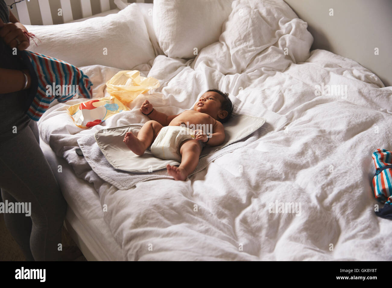 changing baby on bed