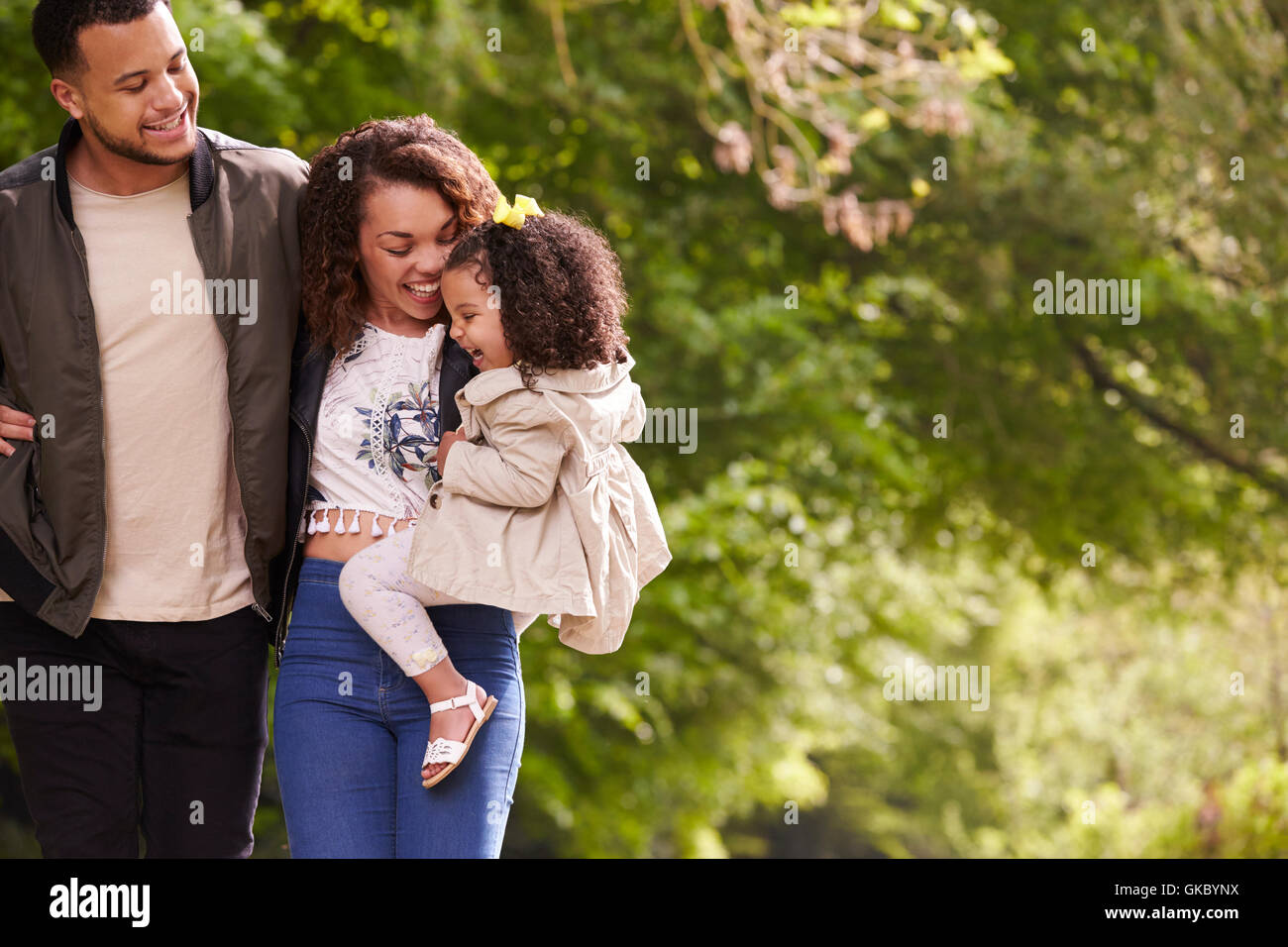 Family of three on a walk, mother holding child, close up Stock Photo