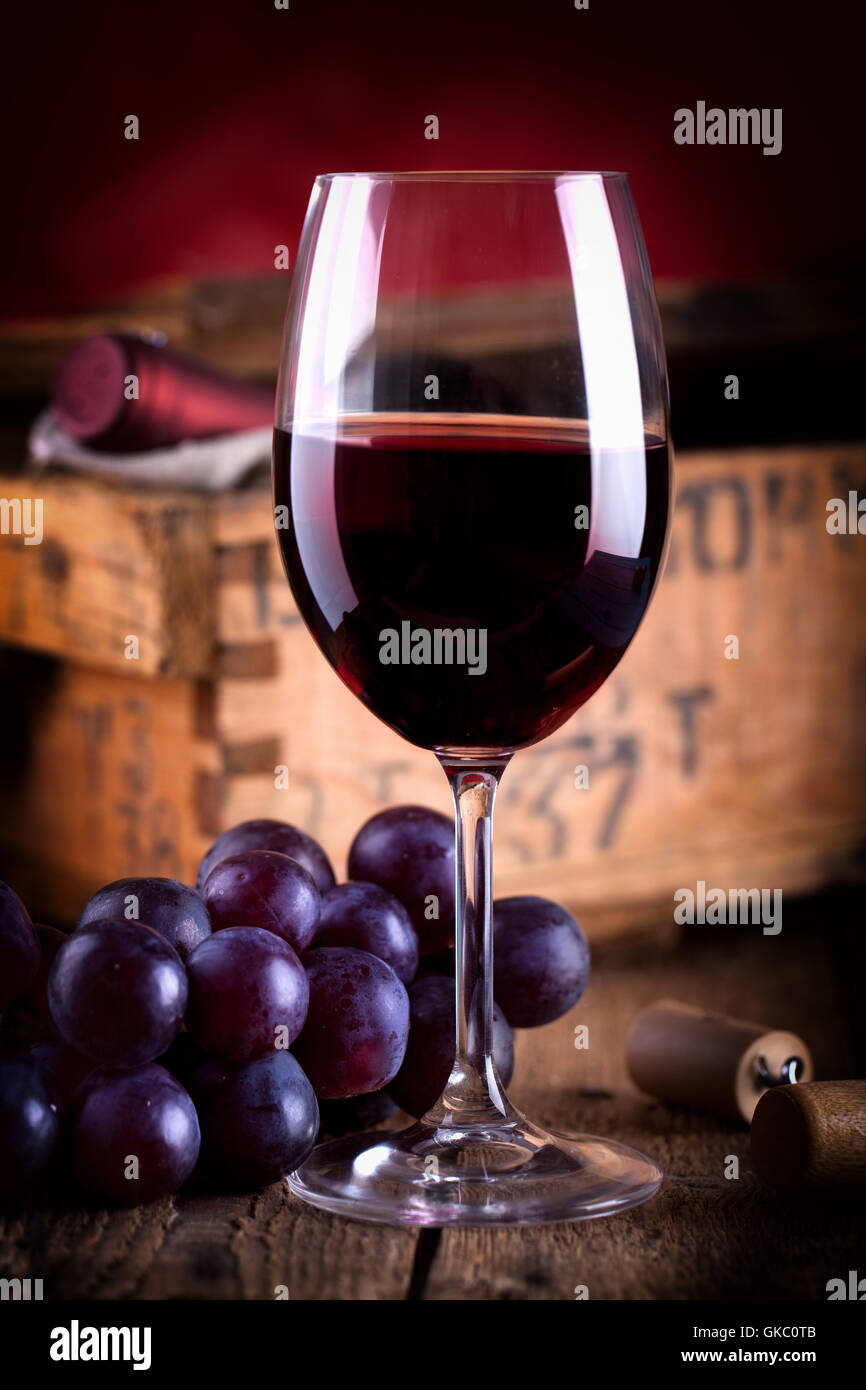 glass of red wine before old wine crate Stock Photo