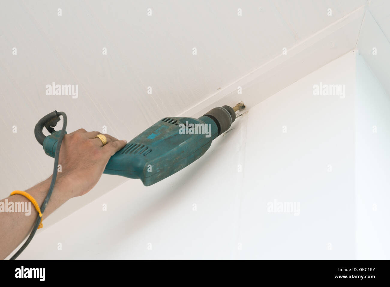 drilling a ceiling with an electric drill Stock Photo