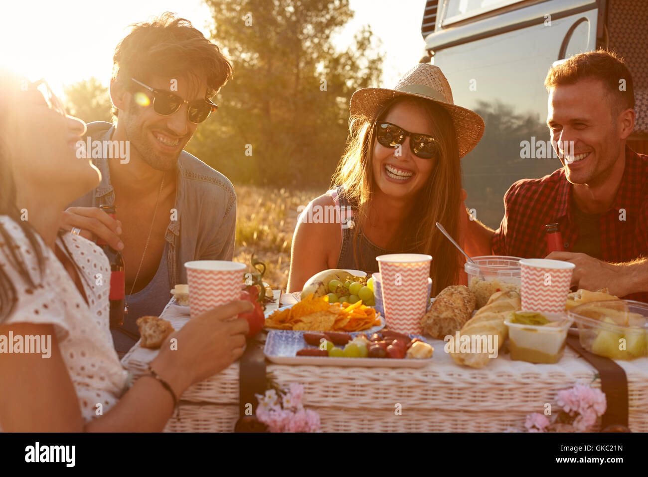 Friends having a picnic beside a camper van, close up Stock Photo