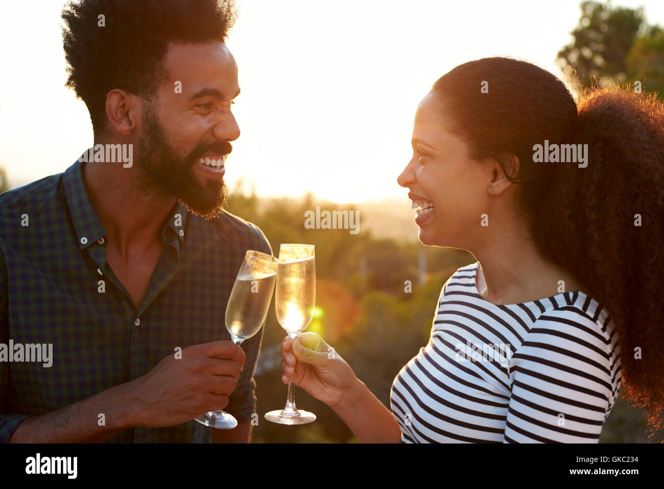 Romantic couple making a toast outdoors Stock Photo