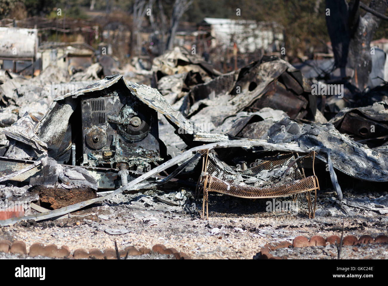 Apartially melted patio bench and the remains of a home in Lower Lake, CA. At least 175 homes were destroyed after the Clayton F Stock Photo