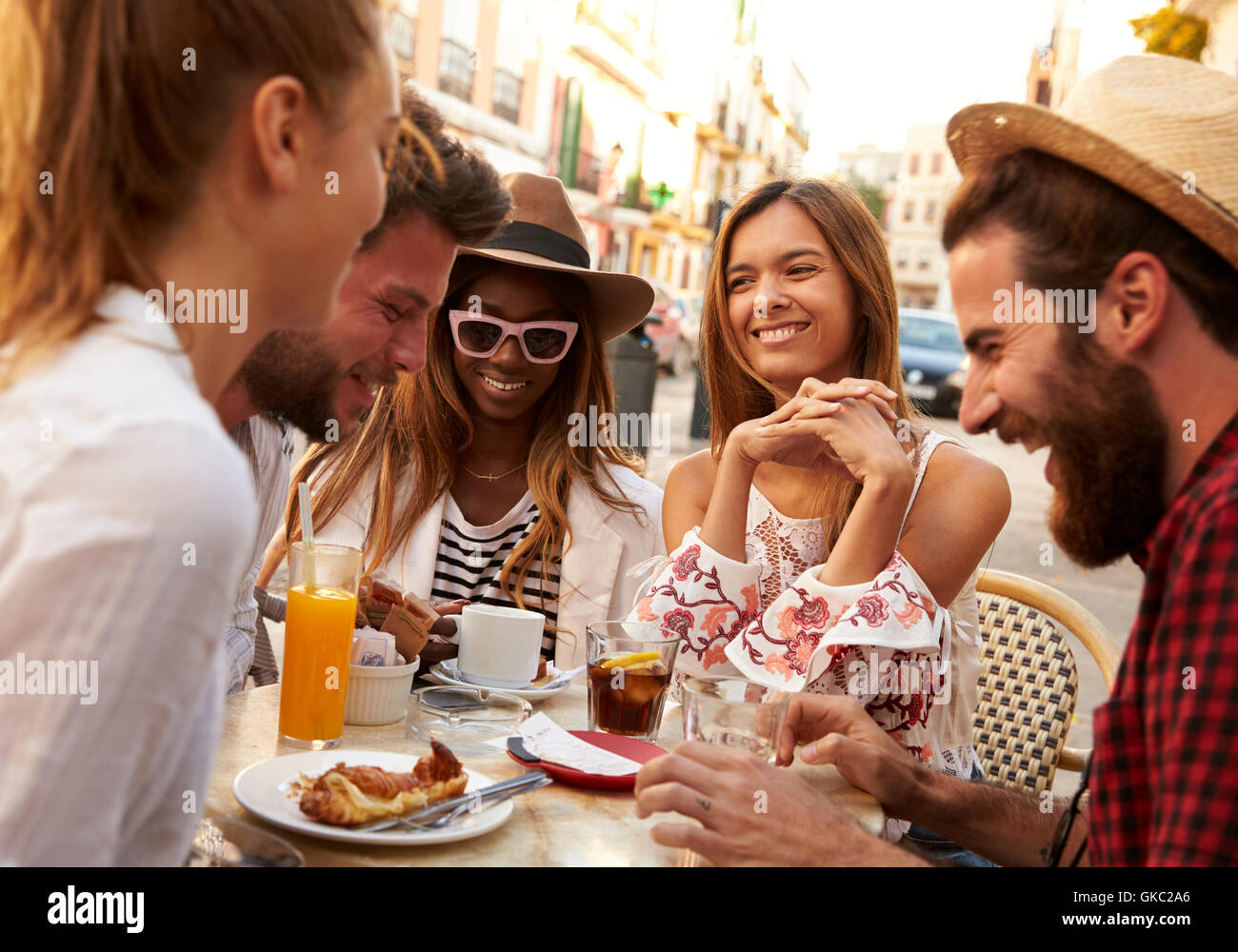 Friends on vacation having fun outside a cafe in Ibiza, close up Stock Photo