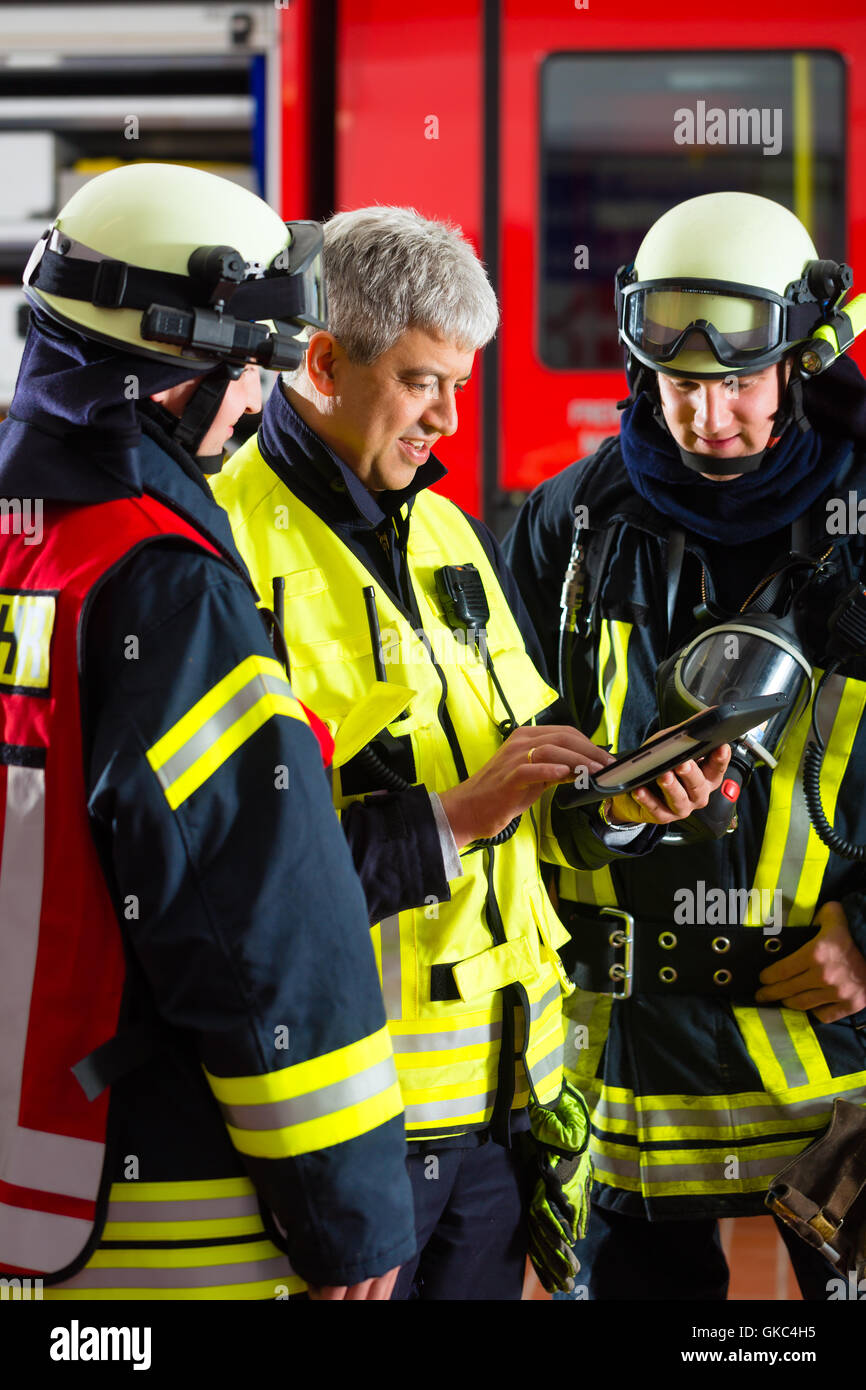 firemen - use planning on tablet computer Stock Photo