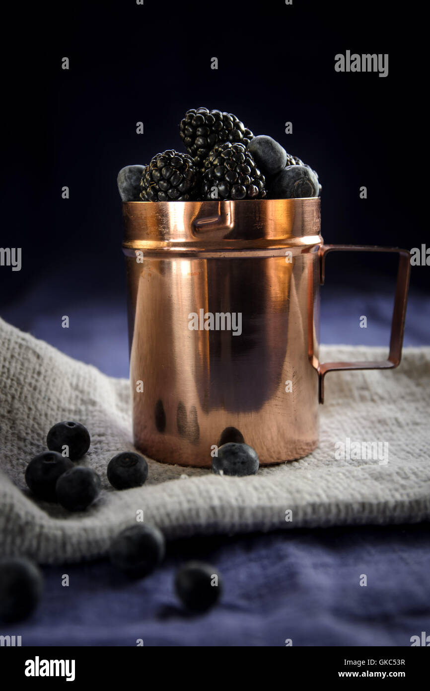 Copper cup with berries Stock Photo