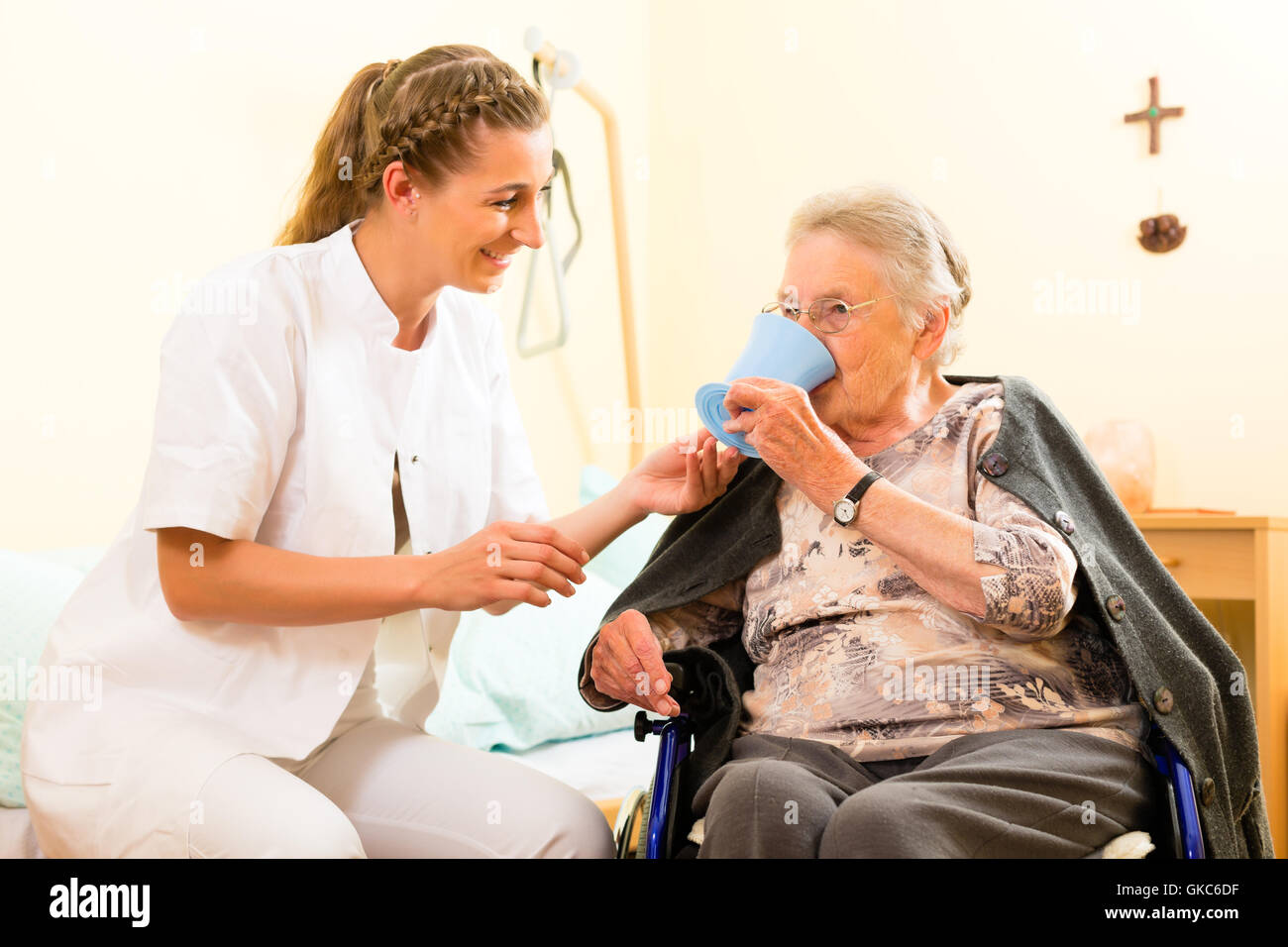 age and nursing - nurse and a senior citizen in a nursing home Stock Photo