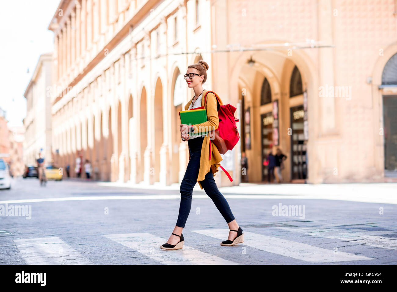 Student walking on the street Stock Photo - Alamy