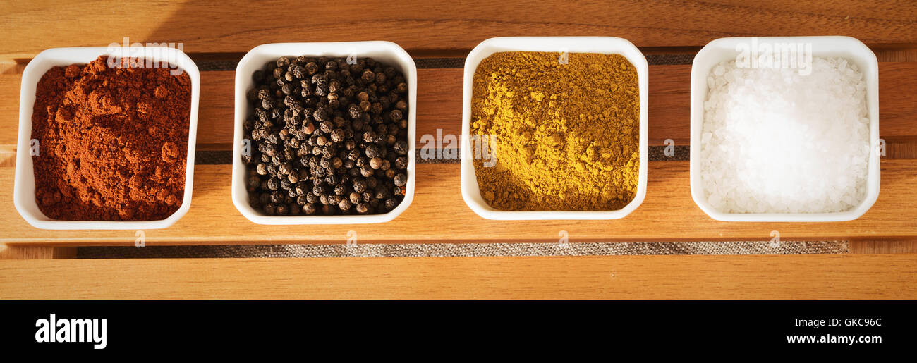 series of small bowls with spices from above Stock Photo