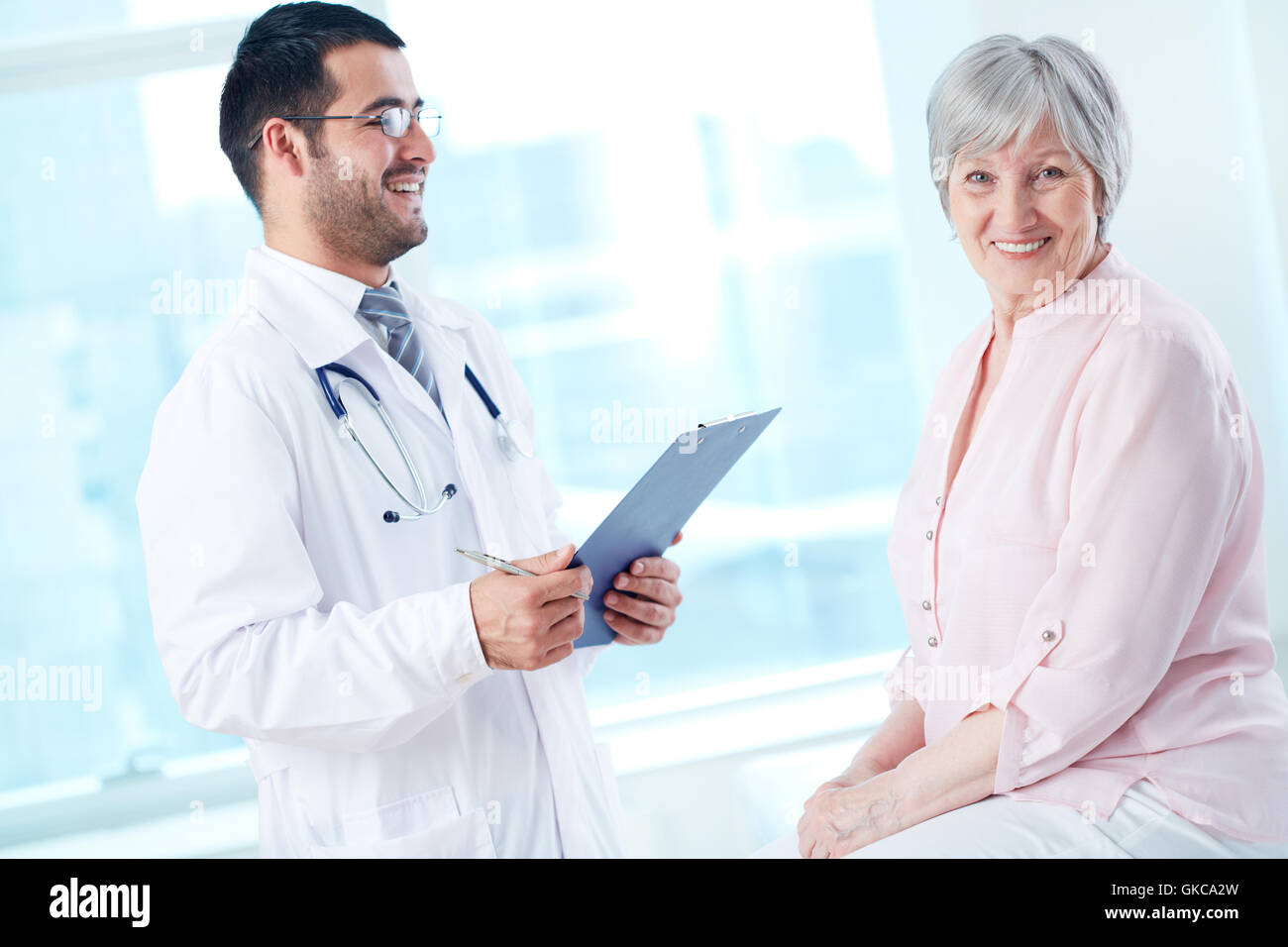 Joyful young doctor consulting hi-res stock photography and images - Alamy
