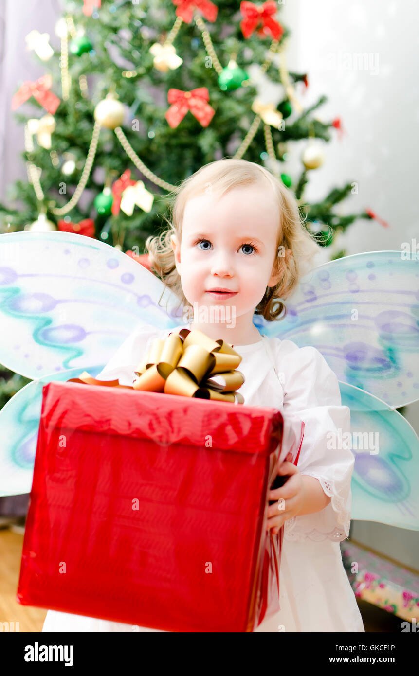 little girl holding christmas gift Stock Photo - Alamy