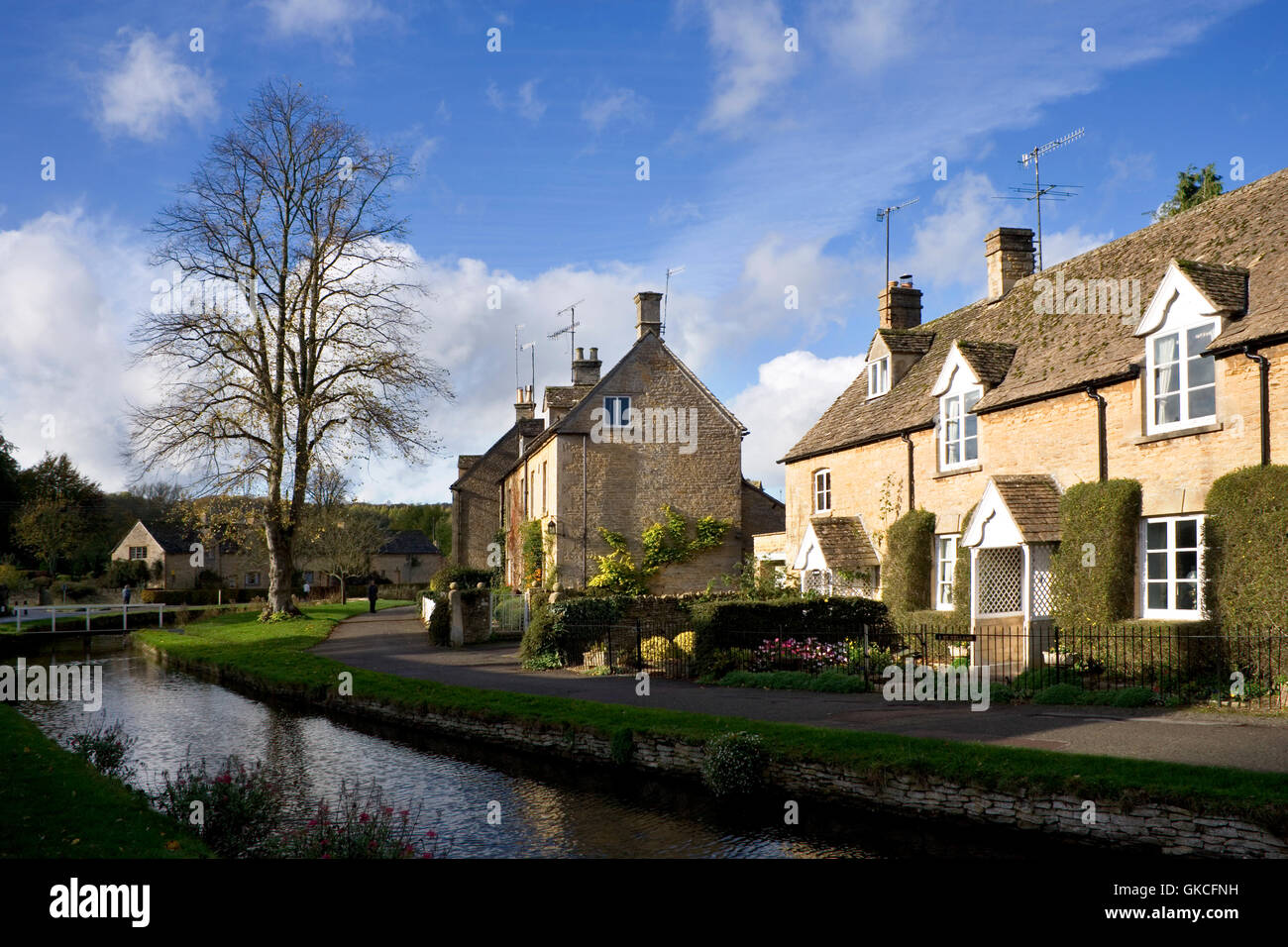 Riverside cotswold stone cottages in autumn sunshine, Lower Slaughter