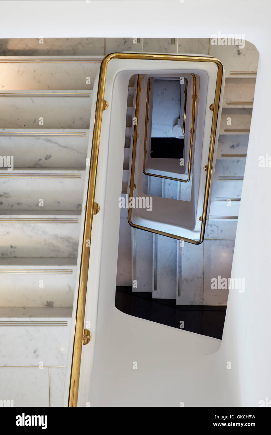 View looking down opulent marble staircase. 54 Brooks Mews, London, United Kingdom. Architect: Stiff + Trevillion Architects, 2016. Stock Photo