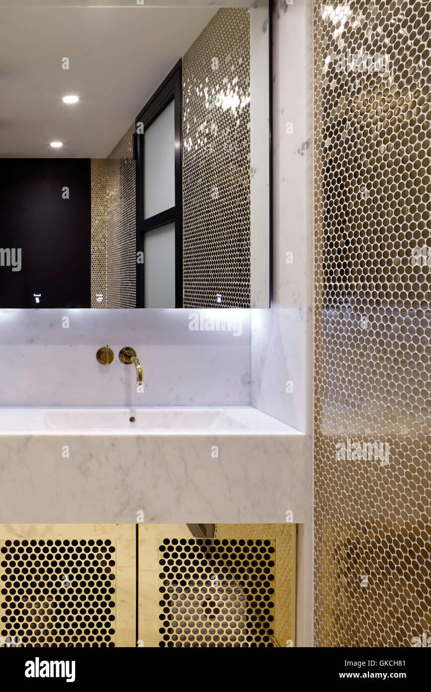Mirror and wash basin detail in good tiled bathroom. 54 Brooks Mews, London, United Kingdom. Architect: Stiff + Trevillion Architects, 2016. Stock Photo