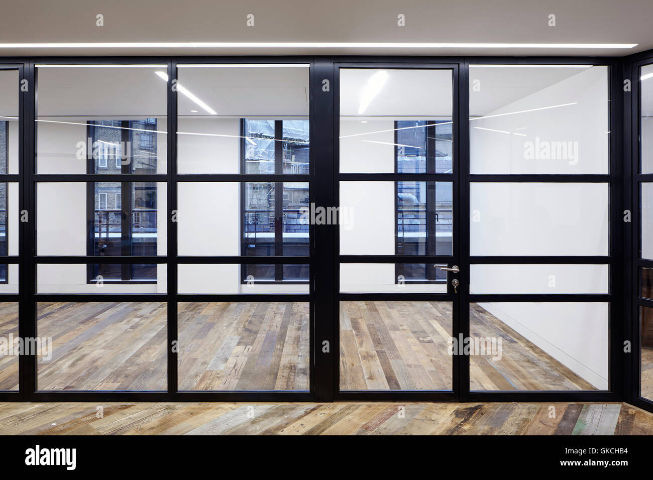 View of the office spaces with reclaimed 16th Century flooring. 54 Brooks Mews, London, United Kingdom. Architect: Stiff + Trevillion Architects, 2016. Stock Photo