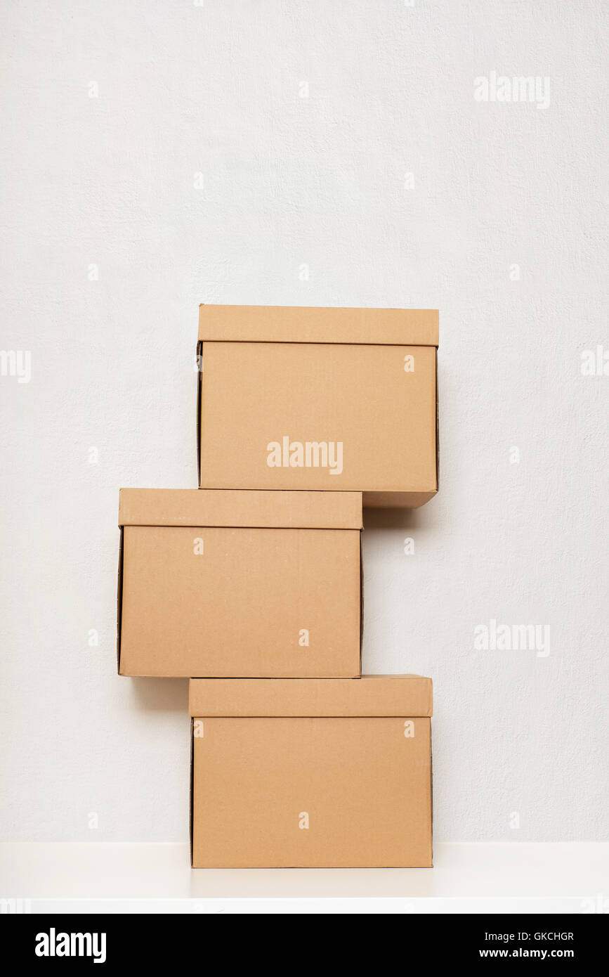 Three cardboard boxes on the white wooden floor Stock Photo Alamy