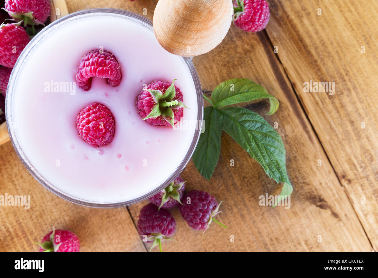 raspberries with milk shake on the wooden background. Stock Photo