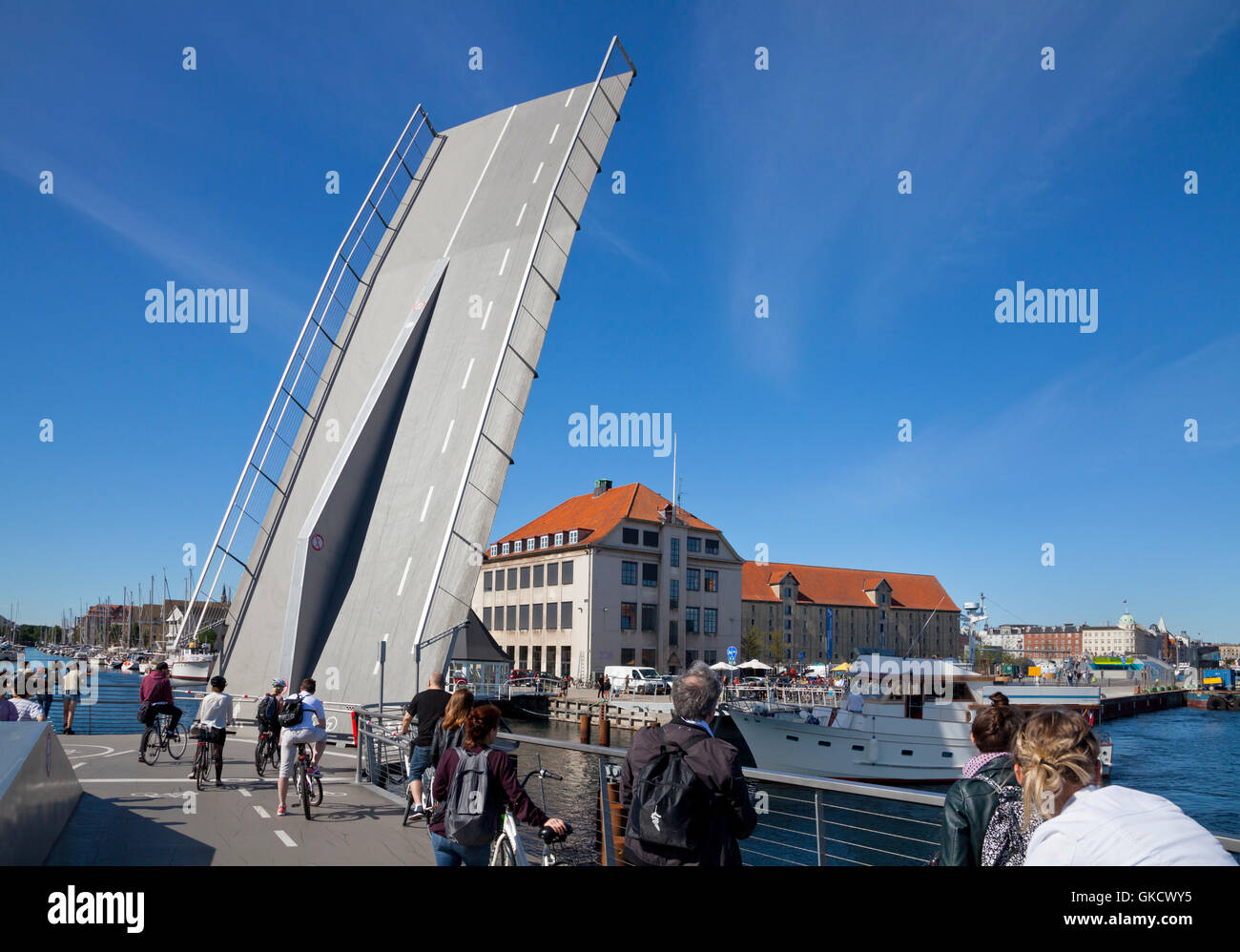 The Trangrav Bridge,Trangravsbroen, a Butterfly 3-Way cyclist and pedestrian bridge across Christianshavn Canal opens for a boat. Copenhagen, Denmark. Stock Photo