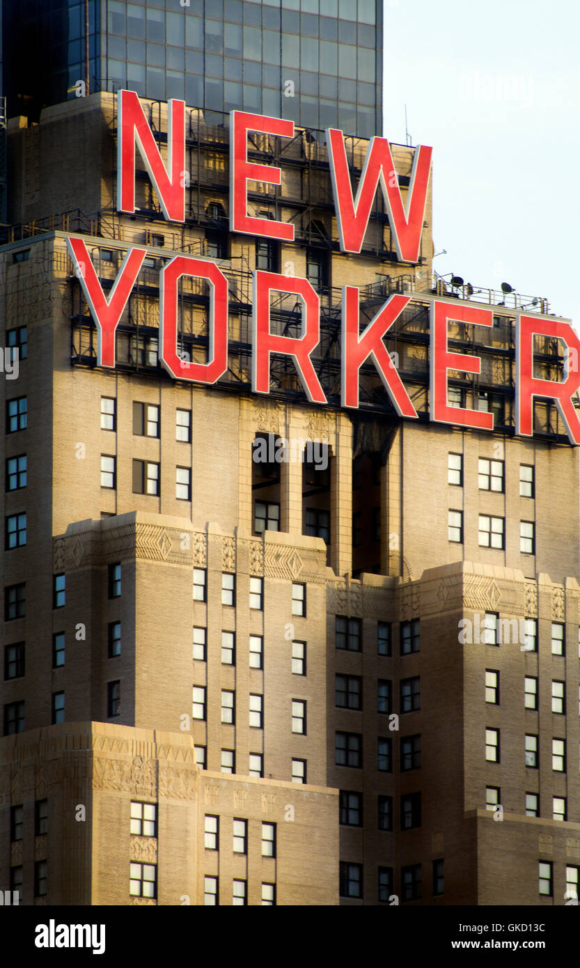 Wyndam New Yorker Hotel Building in New York City with Red Type Brownstone Facade & Office Windows Light Blue Sky Background Hi Stock Photo