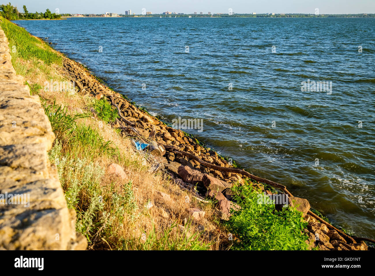 Rip-rap, or shot rock for erosion control lines the banks of Hefner lake in Oklahoma City, Oklahoma, USA. Stock Photo