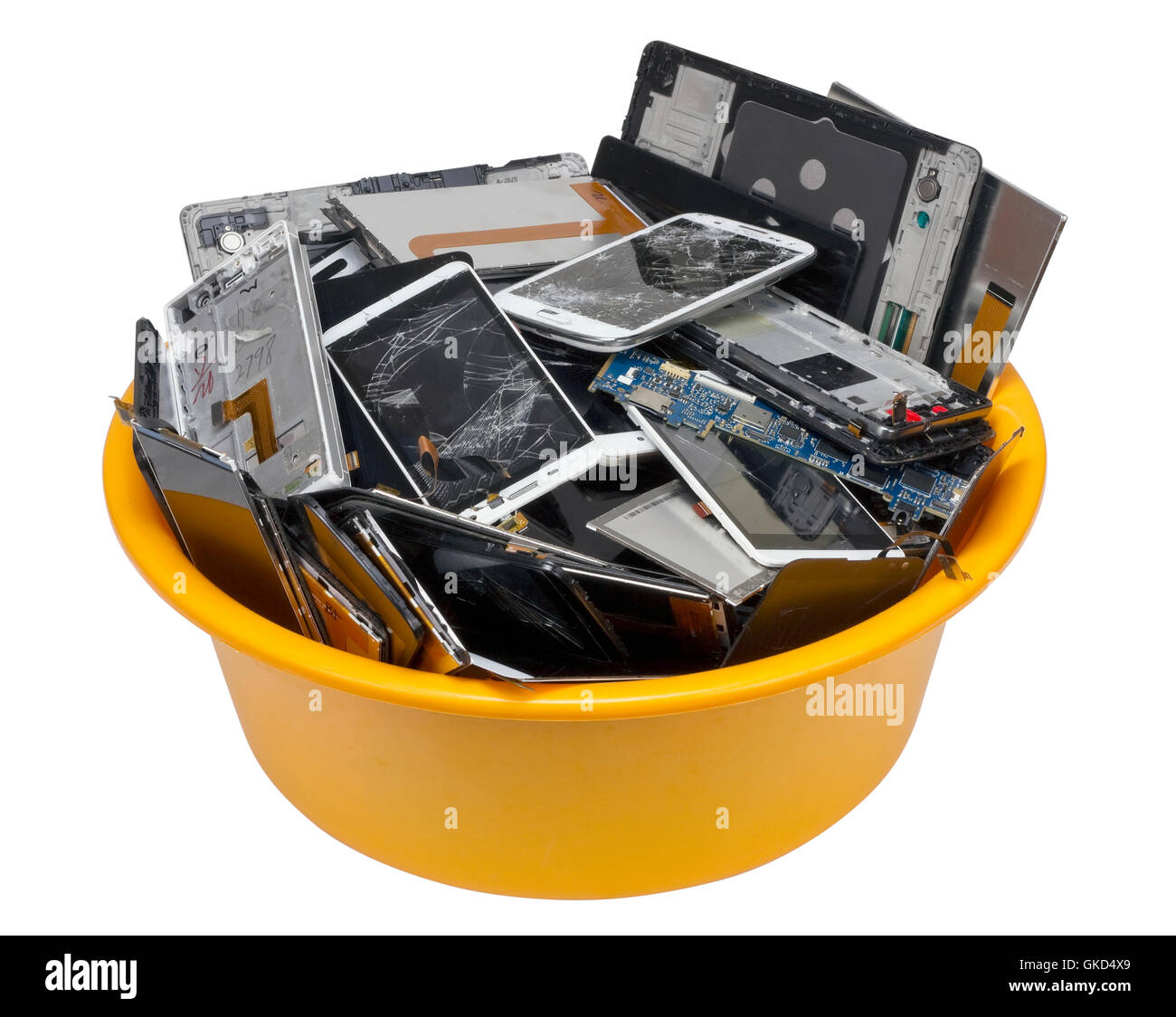 Heap of the  broken  cellular telephotons in the orange plastic container. Mass production devices are prepared for industrial u Stock Photo