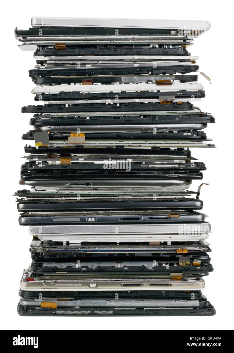 Vertical heap of the  broken  mobile phones closeup. Mass production devices are prepared for industrial utilization. Isolated w Stock Photo