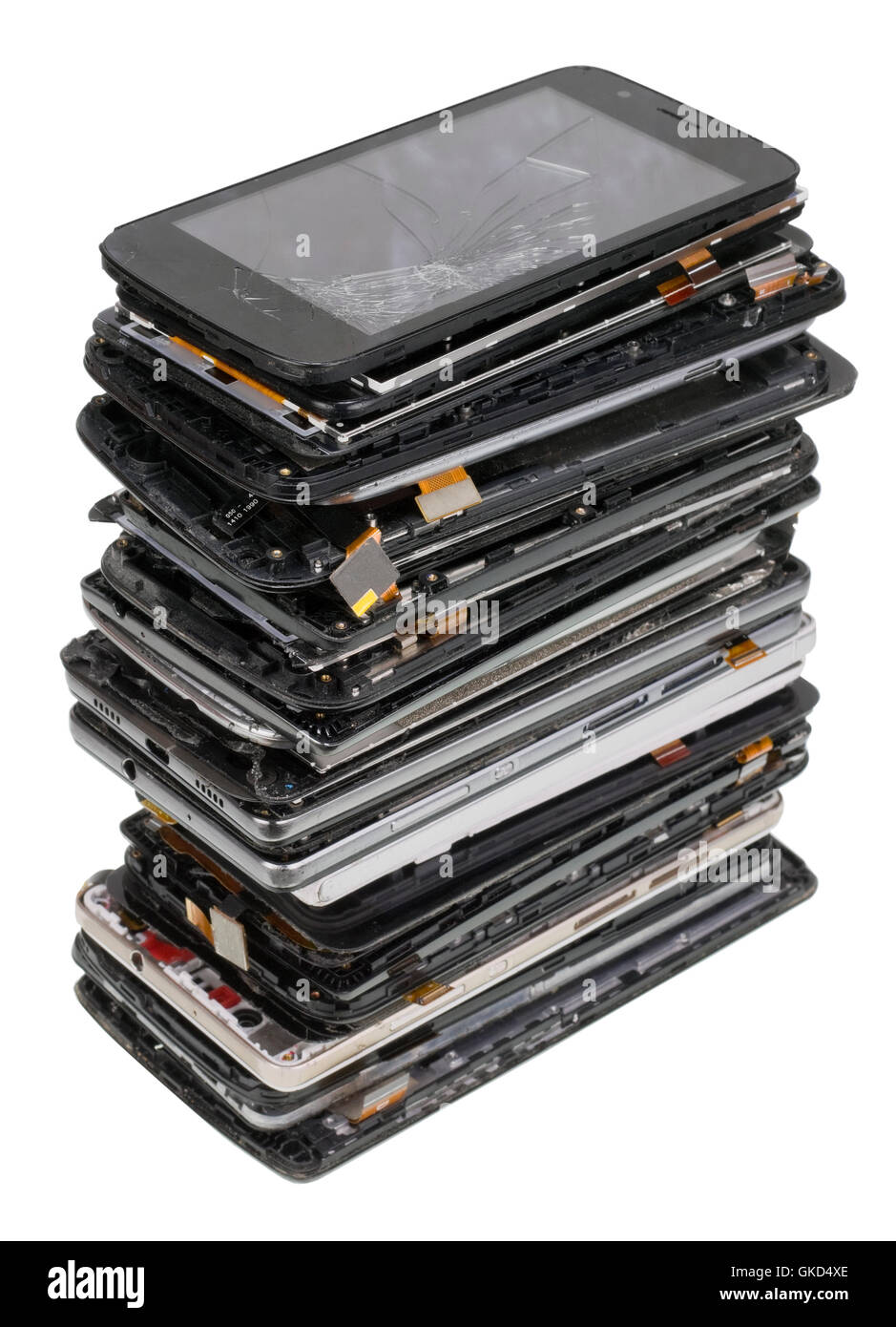 Vertical heap of the  broken  phones closeup. Mass production devices are prepared for industrial utilization. Isolated with pat Stock Photo