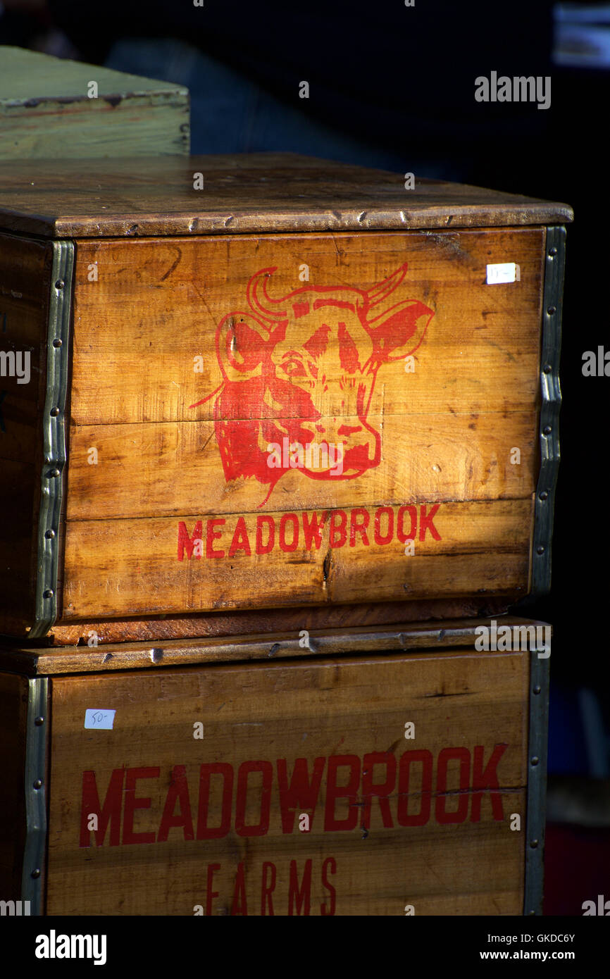 Meadowbrook Red Cow Graphic Stenciled onto Wooden Crate is For Sale at Hell's Kitchen Flea Market during a Sunday Event Stock Photo