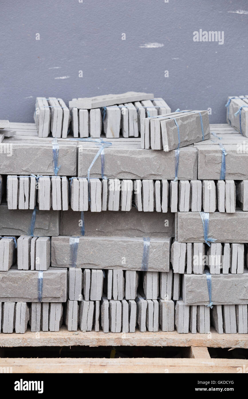 pile of gray stone tiles prepare for install with cement for house decoration Stock Photo