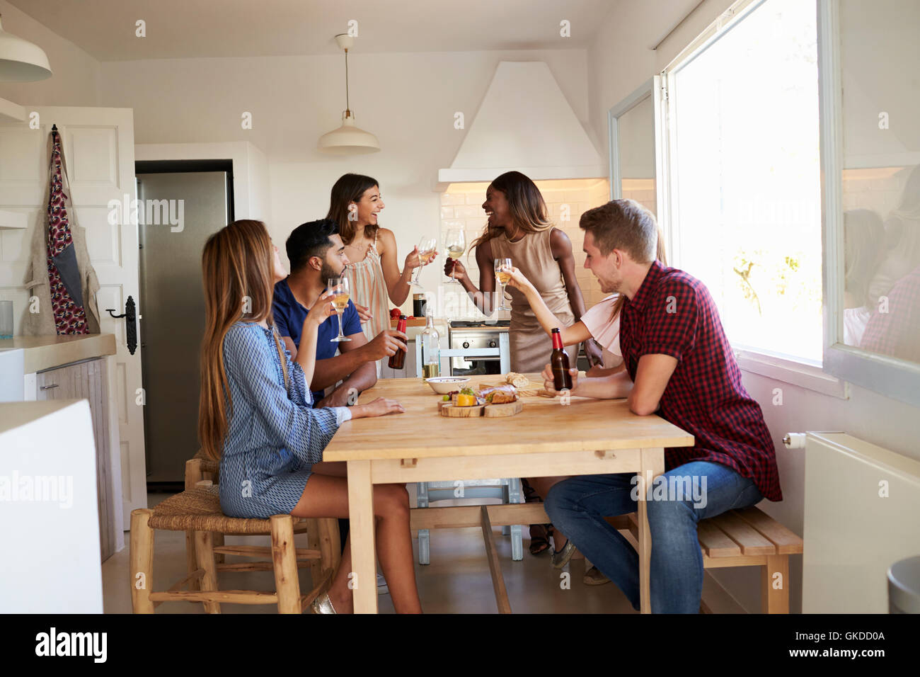 Group of friends at a casual dinner party making a toast Stock Photo