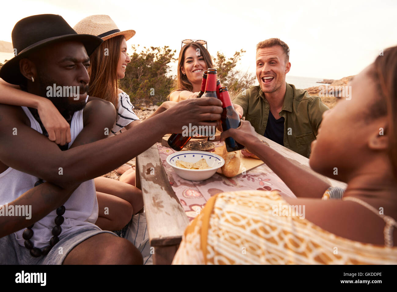 Group Of Friends Making A Toast On Cliff Top Picnic Stock Photo