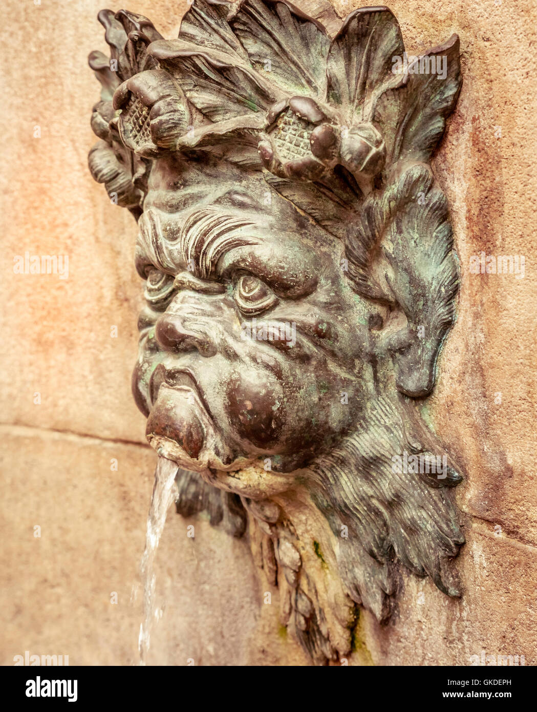 Gothic Face Gargoyle - waterspout of medieval gargoyle on an exterior wall Stock Photo