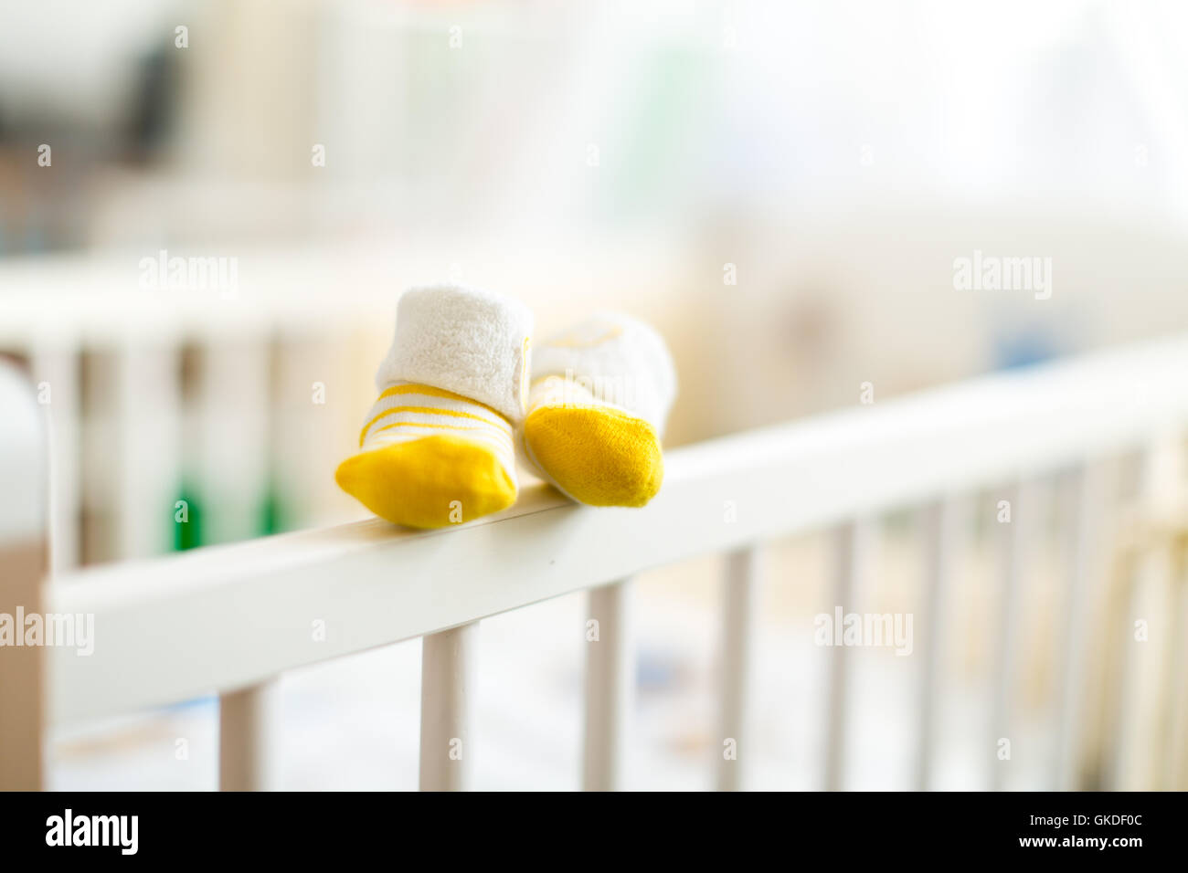baby booties on a cot crib for infants Stock Photo