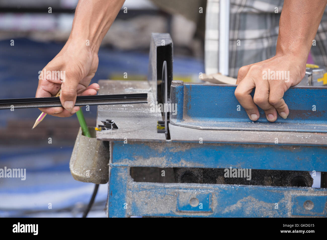 Professional Worker cutting aluminium with grinder blade Stock Photo