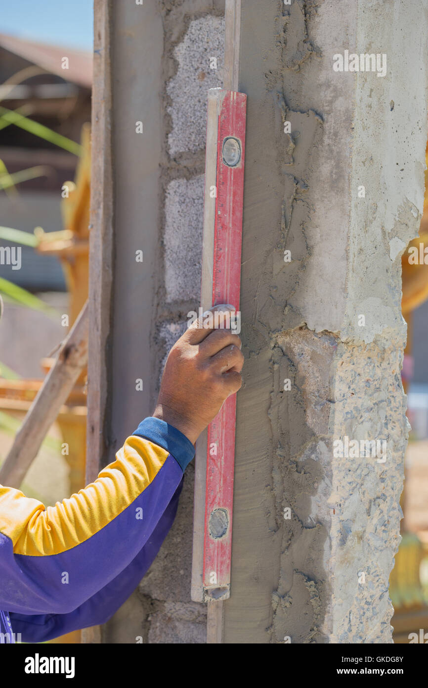 Process fillers and leveling concrete wall with tool Bubble spirit
