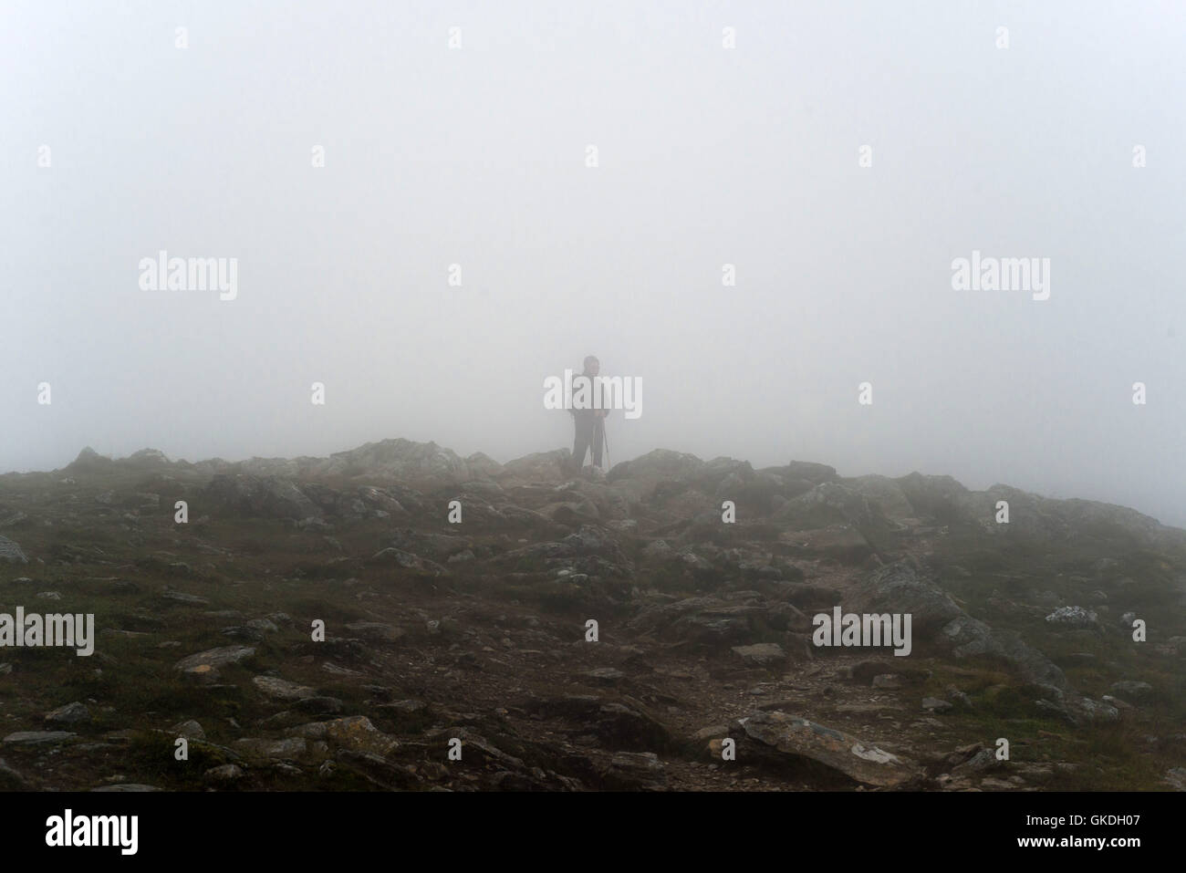 Man standing in low cloud with low visibility on Ben Vorlich (loch earn) Stock Photo