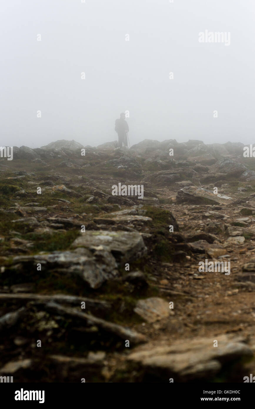 Man standing in low cloud with low visibility on Ben Vorlich (loch earn) Stock Photo