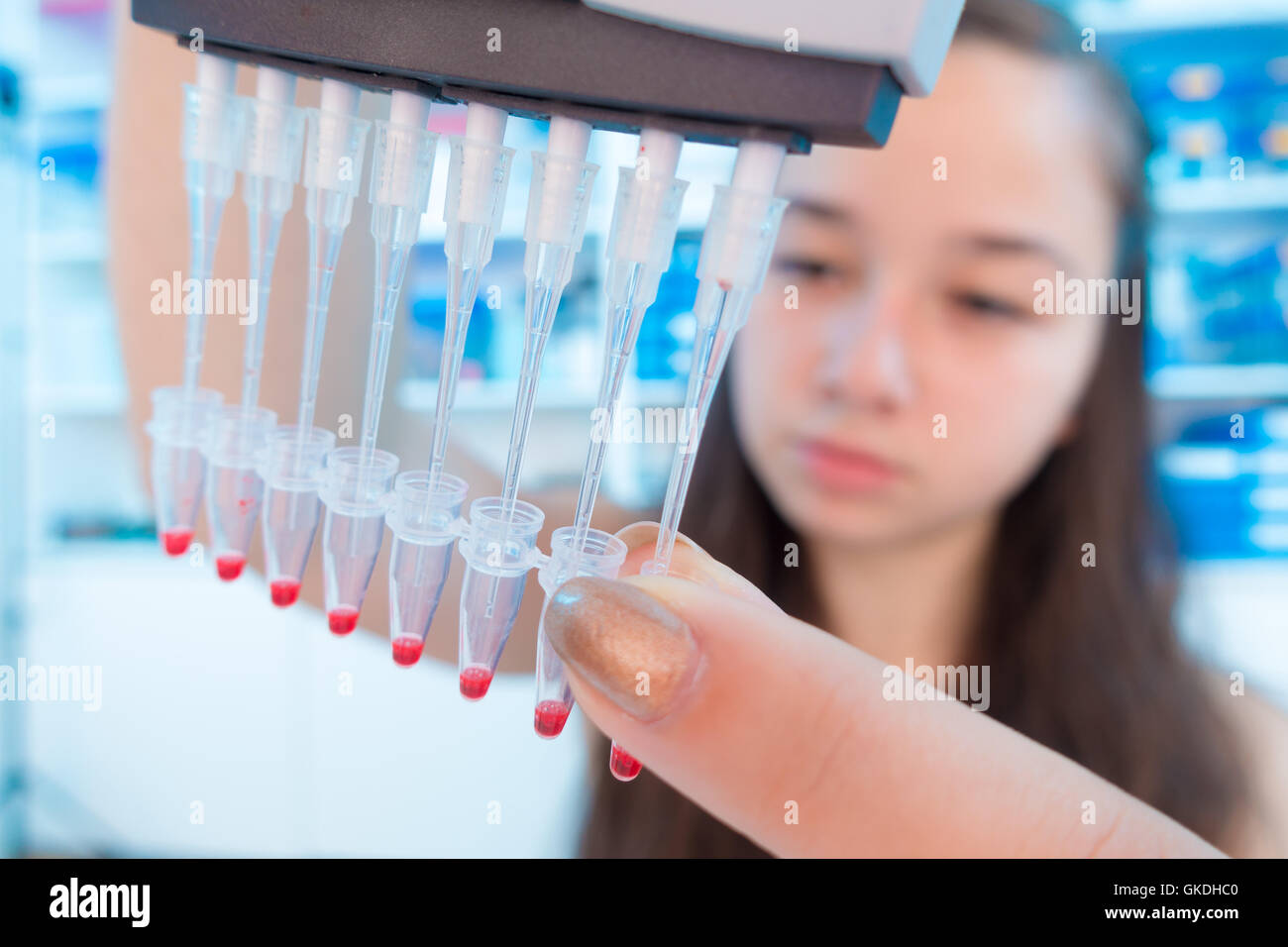Young female scientist loads samples for DNA amplification by PCR Stock ...