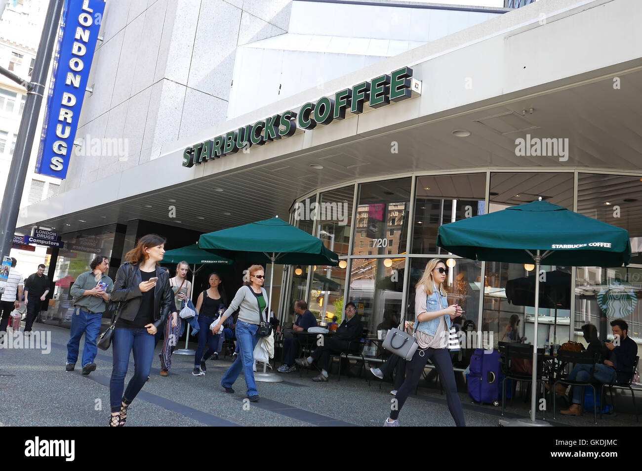 One side of Starbucks coffee on sunny day in downtown Vancouver Stock Photo