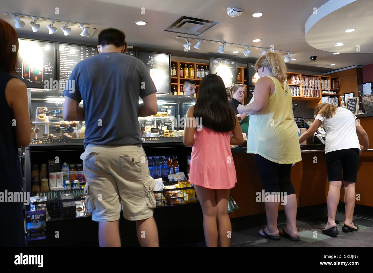 One side of people line up for buying coffee inside Starbucks store Stock Photo