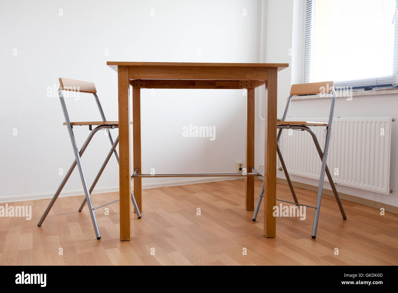 Table and chair in empty room Stock Photo